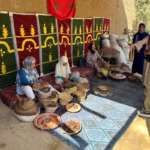 Women's argan oil cooperative in Ourika Valley — local Berber women hand-pressing argan oil near Marrakech