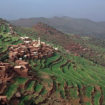 Traditional Berber village in High Atlas Mountains valley — stone houses on hillside on private day trip from Marrakech