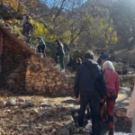 Guided hike to Ourika Valley waterfalls in Atlas Mountains — local guide leading group on rocky trail Morocco Marrakech