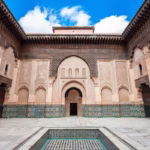 Ben Youssef Madrasa central courtyard with marble pool and carved arabesque stucco — Marrakech heritage tour