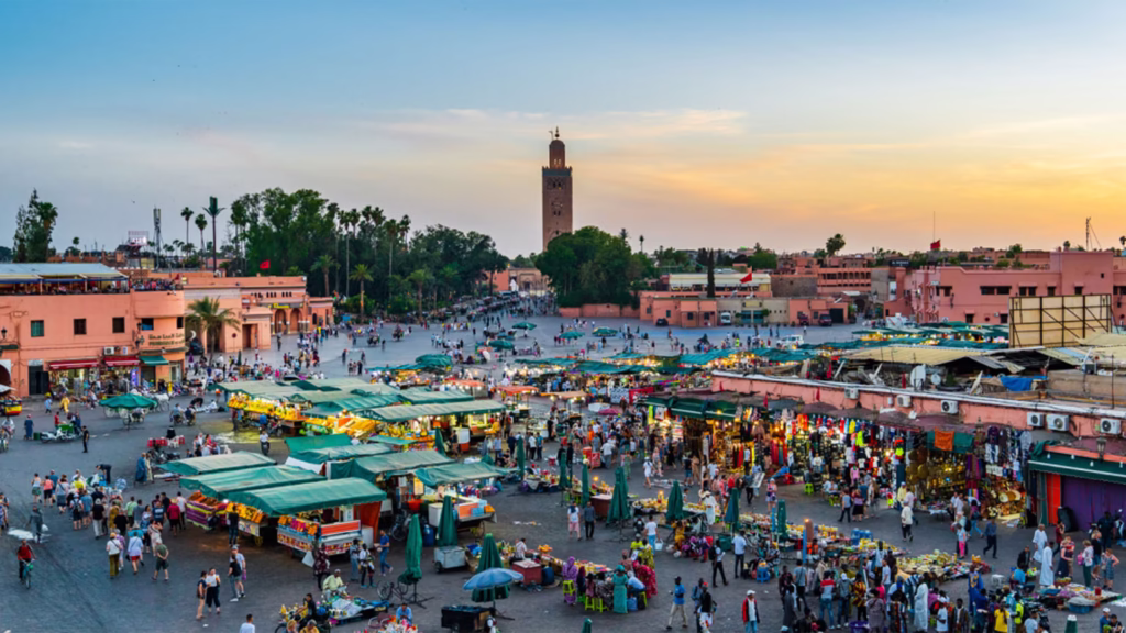 Panoramic view of Djemaa el-Fna square and Marrakech medina rooftops at dusk