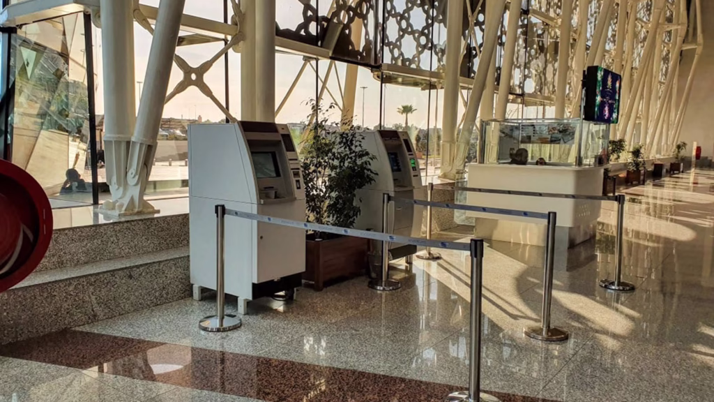 Currency exchange bureau inside Marrakech airport arrivals hall showing Moroccan dirham rates