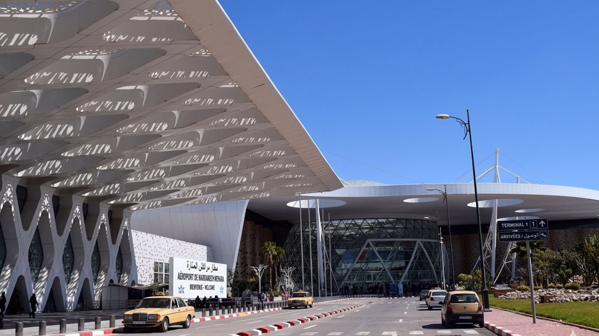 Marrakech Menara Airport arrivals terminal exterior entrance with signage and clear blue sky
