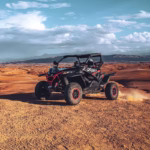 Agafay buggy and camel ride adventure from Marrakech — off-road buggy on rocky desert plateau with Atlas Mountains backdrop