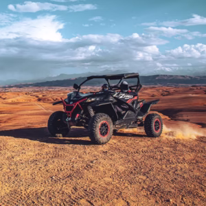 Agafay buggy and camel ride adventure from Marrakech — off-road buggy on rocky desert plateau with Atlas Mountains backdrop