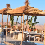 Agafay pool lounge areas with shaded seating and desert views — comfortable relaxation zone in Agafay Desert near Marrakech