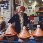 Moroccan dinner on Marrakech food tour — local restaurant tajine or open-air Chwa barbecue grill medina Morocco